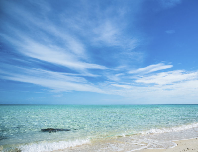 Real beach photo of white sand and blue sea of MSC ocean cay