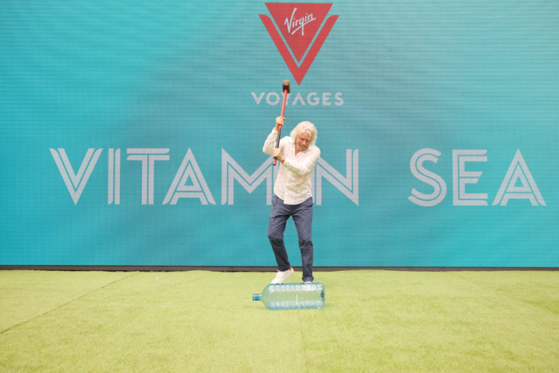 Richard Branson taking sledgehammer to plastic water bottle to market Virgin Voyages sustainable cruise option