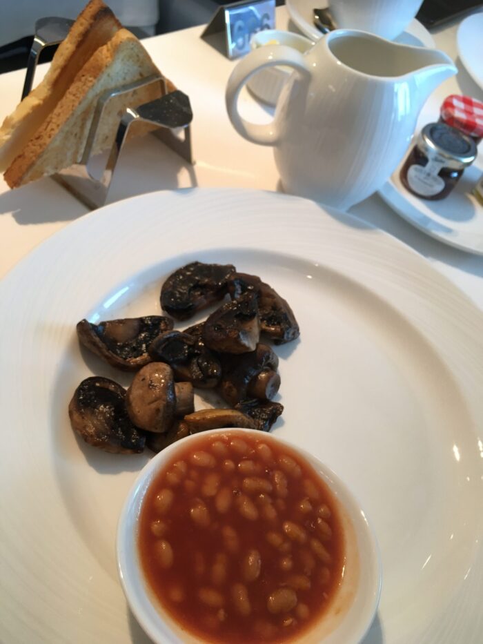 P&O Iona vegan MDR breakfast some mushrooms and small bowl of baked beans on a large plate